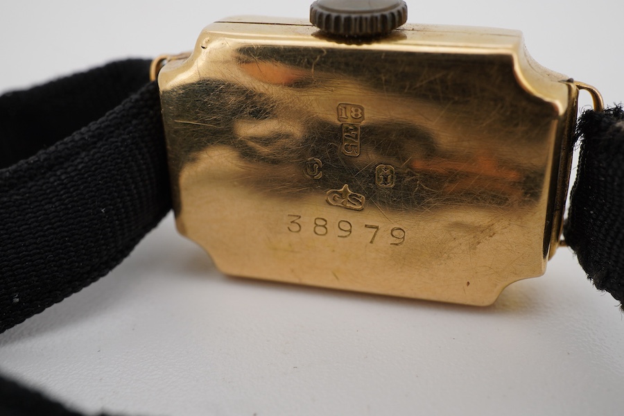 A lady's George V 18ct gold manual wind wrist watch, with Arabic dial, on a black sash strap with a 9ct buckle.